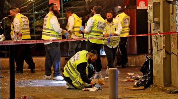 Forensic experts investigate the scene of shooting in Tel Aviv on Thursday.