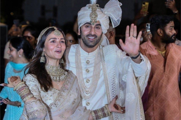 Alia Bhatt and Rabir Kapoor pose for photos after their wedding.