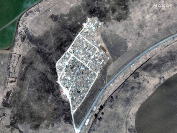 A satellite image shows the expansion of new graves at a cemetery in Vynohradne, near Mariupol, Ukraine, on March 29. — courtesy Maxar Technologies