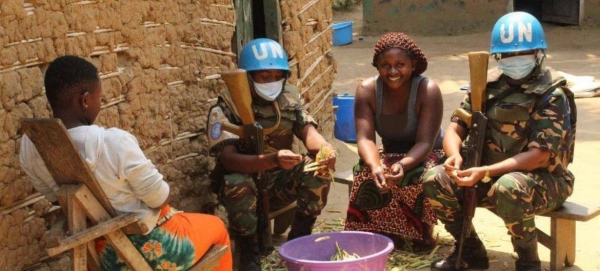 Peacekeepers from Tanzania serving with the UN Stabilization Mission in the Democratic Republic of the Congo (MONUSCO) meet with local community women.