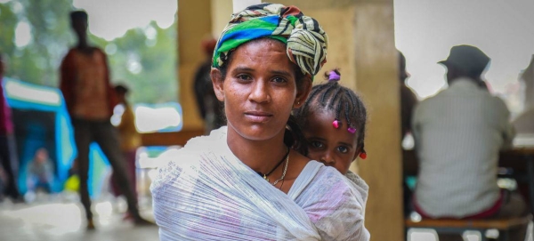 A displaced woman carries her baby in Mekelle, capital of Tigray, Ethiopia.