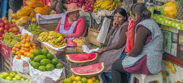 

Women fruit and vegetable vendors chat at a market in La Paz, Bolivia. — courtesy Unsplash/Lesly Derksen