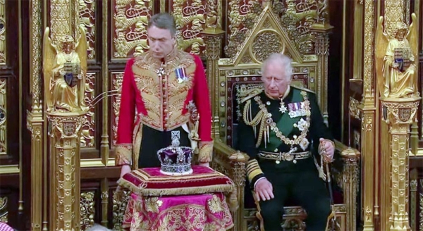 Prince Charles sits next to the Queen's crown during the state opening of Parliament, at the Palace of Westminster in London, Tuesday.