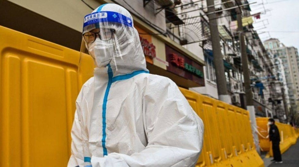 A worker, wearing protective gear, in Shanghai.
