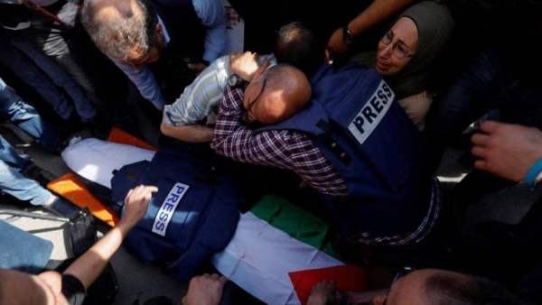 Mourners, including journalists, react next to the body of Al Jazeera reporter Shireen Abu Akleh.