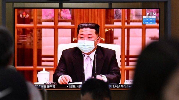 North Korean leader Kim Jong Un appeared in a face mask on television for the first time on Thursday to order nationwide lockdowns.