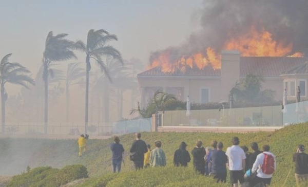 Residents watch a mansion burn.