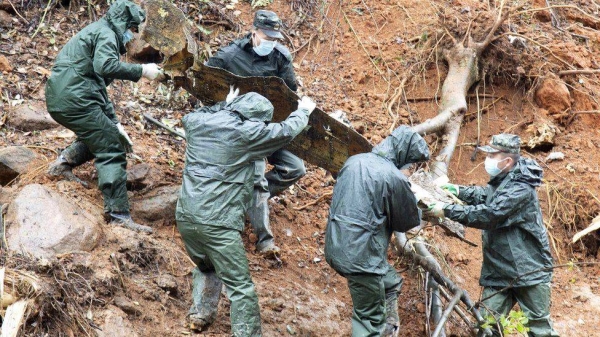 Emergency workers at the site of the China Eastern Airlines plane crash
