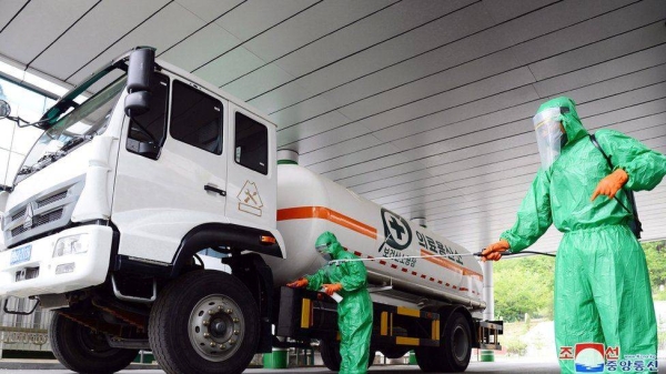A worker disinfects a vehicle carrying medical oxygen, in Pyongyang.