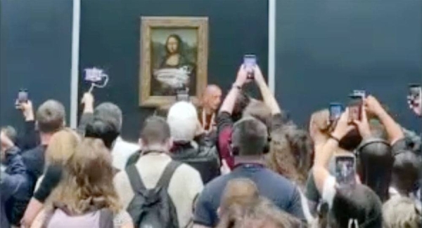 The world's most famous painting has been attacked with cake by a man disguised as an old woman. — courtesy Twitter