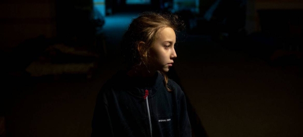 A nine-year-old girl stands in an underground car park in Kharkiv where she is sheltering with her parents during the conflict in Ukraine.