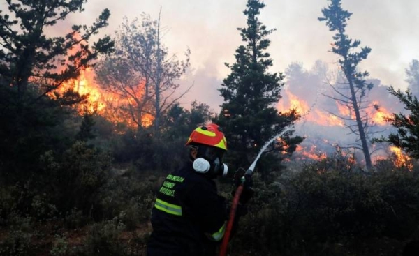 Wildfire rages near Athens, damaging homes