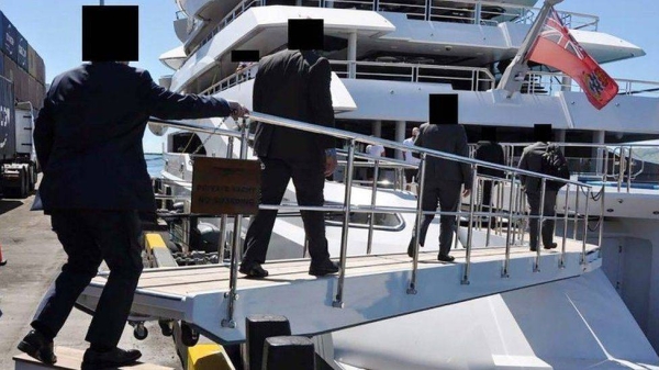 An FBI handout shows US agents boarding the 106m yacht in April.