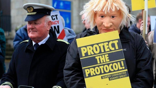 Demonstrators protest outside Hillsborough Castle, ahead of a visit by British Prime Minister Boris Johnson, in Hillsborough, Northern Ireland, Monday, May, 16, 2022.