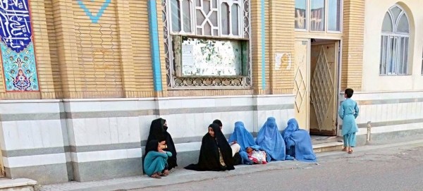 Women and children wait for alms in front of a Mosque in Herat City, Afghanistan.