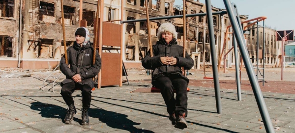 Two 14-year-olds play on the swings at their former school in Kharkiv, northeast Ukraine, after it was destroyed by shelling.