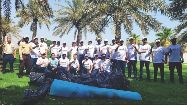 Farabi Petrochemicals employees pose after beach clean-up at the Dareen Beach in Jubail Industrial City.