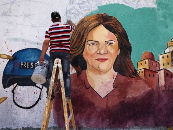 Palestinian artists paint a mural in honor of slain veteran Al Jazeera journalist Shireen Abu Akleh in Gaza City, after she was killed on May 11. 