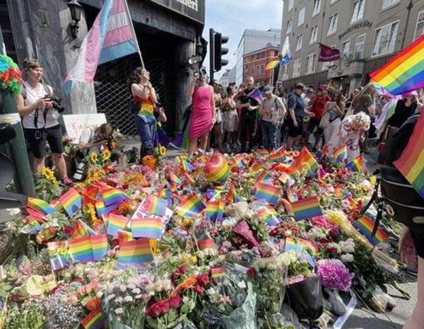 People comfort each other at the scene of a shooting in central Oslo, Saturday.