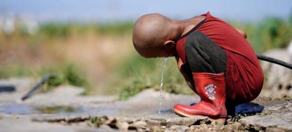 A child drinks water from the only source in Hesbi Camp in Saida, Lebanon.