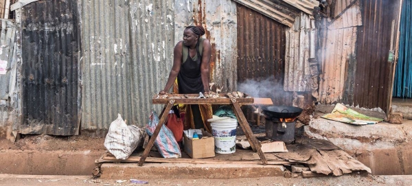 A female street vendor sells food in Africa.