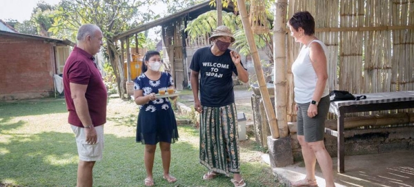 Dekha Dewandana carries his guest suitcase at Esa di Kubu Homestay in Sudaji Village, Buleleng, Bali, Indonesia. — courtesy Putu Sayoga for ILO