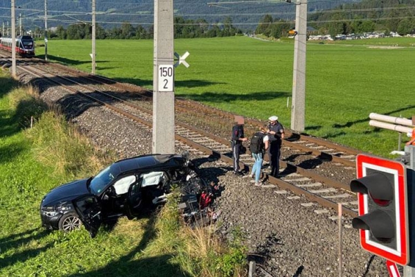Austrian police inspect the accident scene in St. Johann in Tyrol where a Saudi citizen and his child died when a train crashed with his car on Wednesday 