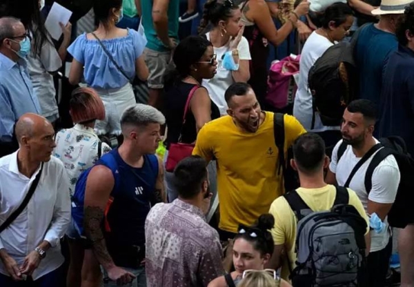 Passengers wait at Atocha train station in Madrid on Monday.
