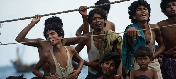 Stranded Rohingya boat people, desperate for food and water, sit on the deck of an abandoned smugglers' boat drifting in Thai waters off the southern island of Koh Lipe in the Andaman sea. (file).