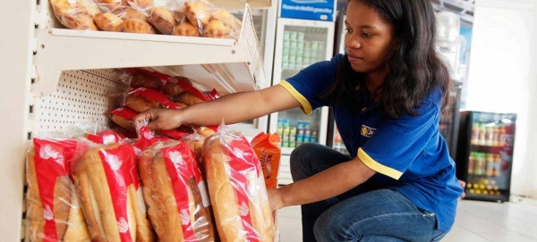 A young female employee works at a gas station in Antsirabe. Madagascar.