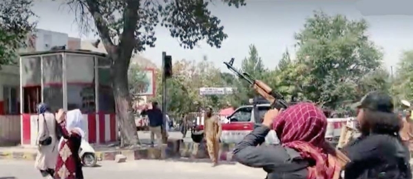 Taliban fighters fire in air to disperse Afghan women protesters in Kabul on Saturday.