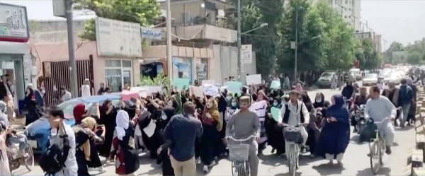 Taliban fighters fire in air to disperse Afghan women protesters in Kabul on Saturday.