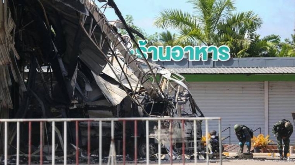 Thai bomb squad personnel inspect the damage at the Bangchak gas station after an attack, in Nong Chik district in southern Thailand's Pattani province, on August 17