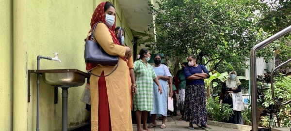 Women wait for their turn to receive food vouchers at a government clinic in Colombo’s Kuppiyawatta as part of WFP’s emergence food assistance response..