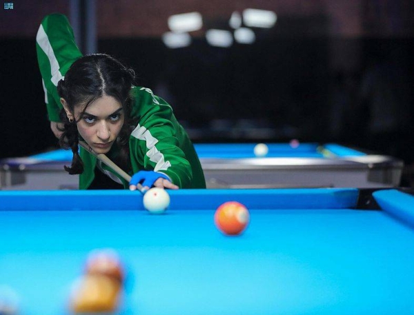 A cueist prepares to shoot during the qualifying rounds of the Billiards event.