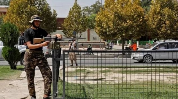 A Taliban fighter stands guard in front of the embassy after the blast.