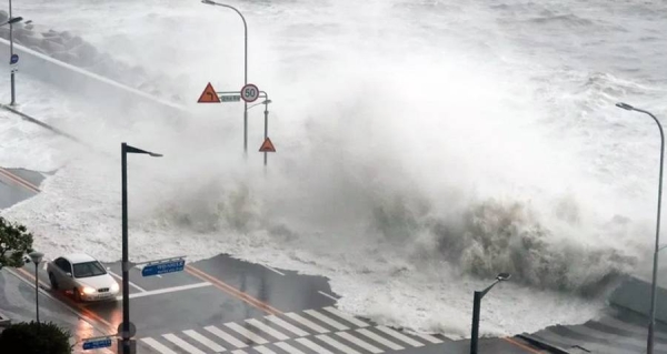 High tides whipped up by the typhoon crash onto a road in Pohang, an eastern coastal city