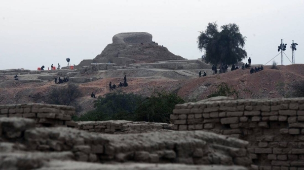 Pakistani policemen sit around the ancient ruins of Moenjodaro, the UNESCO World Heritage site on February 1, 2014.