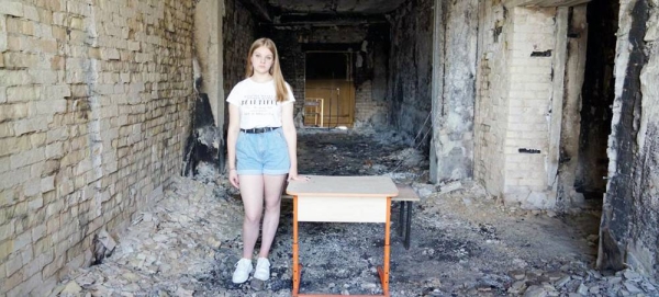 15-year-old Arina stands on the territory of the Irpin school, which was heavily bombed in March 2022. — courtesy UNICEF