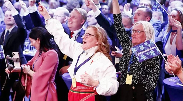 Supporters of the Sweden Democrats reacts on the results of the exit polls at the party's election watch near Stockholm, Sunday. — courtesy TT News Agency
