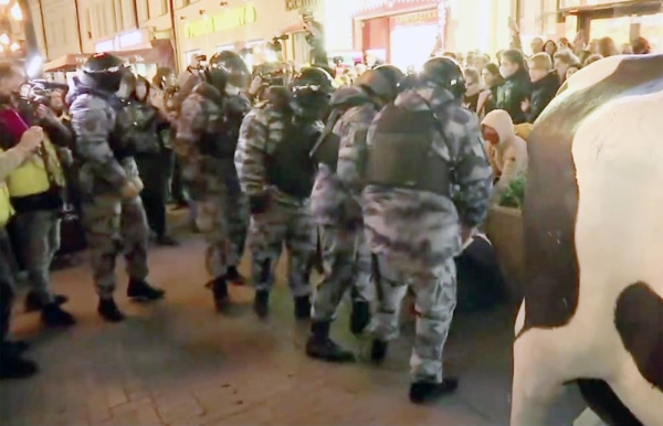 Screenshots of riot police detain demonstrators during a protest against mobilization in Moscow, Russia, Wednesday.