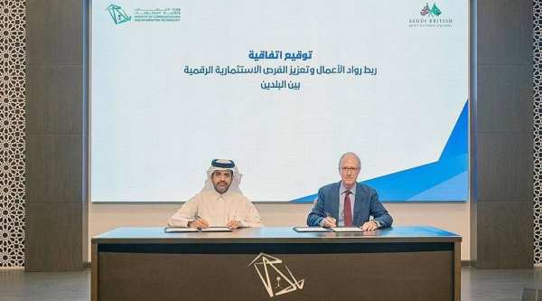 Undersecretary of the Ministry of Communications and Information Technology for Technology Ibrahim Al-Nasser and SBJBC CEO Chris Innes-Hopkins sign the MoU.