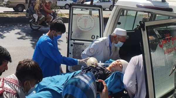 Relatives and medical staff shift a wounded girl from an ambulance outside a hospital in Kabul