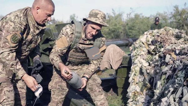 Ukrainian soldiers carry ammunition for a Ukrainian D-30 howitzer near Siversk, Donetsk region, Ukraine, Saturday.