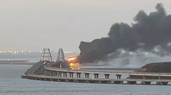 A view shows a fire on the Kerch bridge at sunrise in the Kerch Strait, Crimea, on Saturday. — Courtesy photo