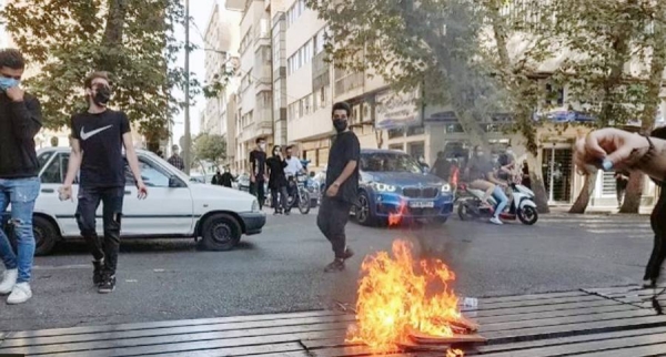 Protesters clash with police during a protest over the death of young woman Mahsa Amini in Tehran, Iran, on Sunday.