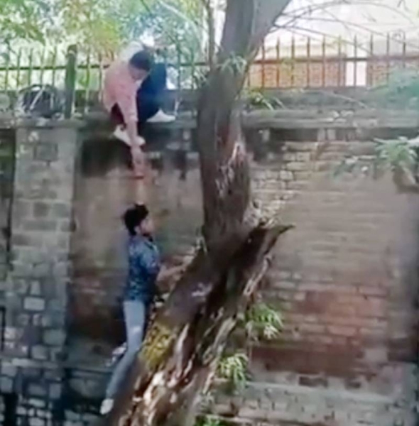 Indian police have opened an investigation after a viral video showed some men scaling the walls of a women's college in capital city Delhi.