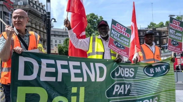 RMT union members picket outside Victoria train station in this June 21 file photo.