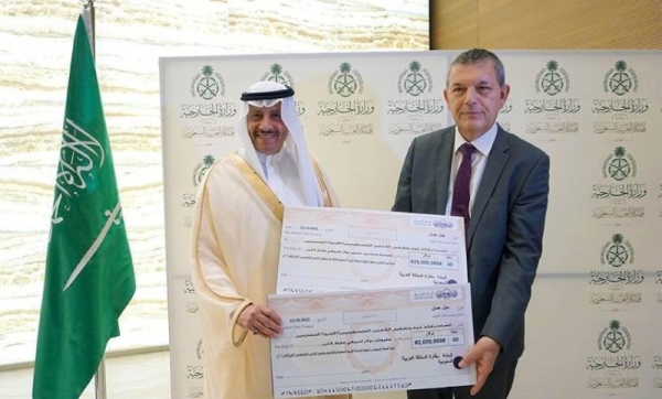 Saudi Arabia’s Ambassador to Jordan Nayef Al-Sudairi hands over checks amounting to $27 million to UNRWA Commissioner-General Philippe Lazzarini in Amman on Sunday.