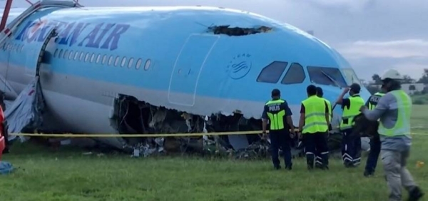 The Korean Air plane remained stuck in the grass at the end of the lone runway at the Mactan Cebu International Airport on Monday.